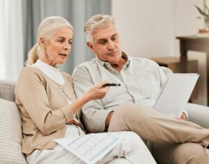 Old people with life insurance application, retirement and reading paperwork, partner with investme