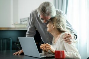 Retired couple working and check data information with laptop on table in living room at home.
