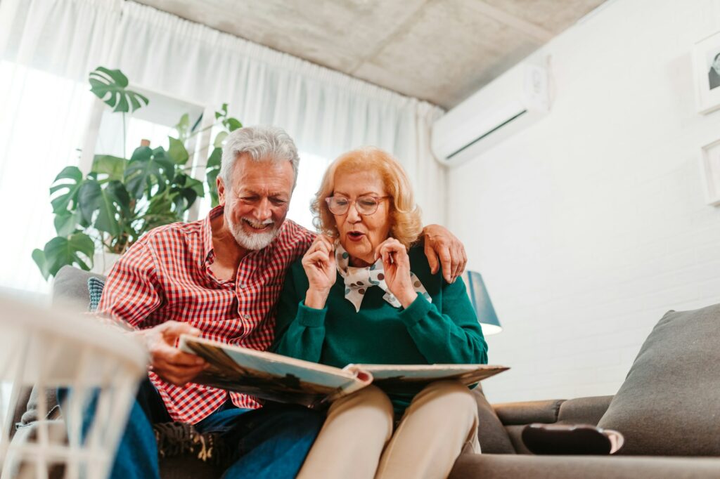 Happy couple looking at old family photos. Happy memories are everything.